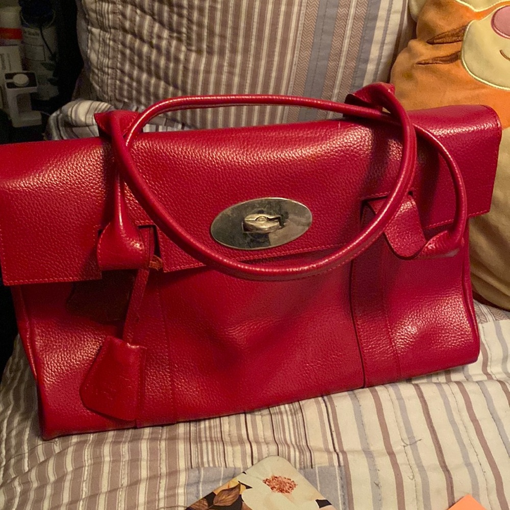 Red Our Tribe brand medium sized 100% leather bag.